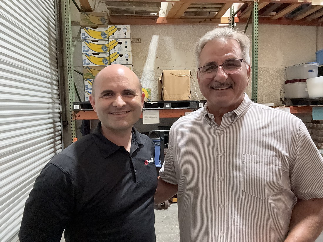 Observer Publisher Brian McMillan, with Grace Community Food Pantry founder Charles Silano.