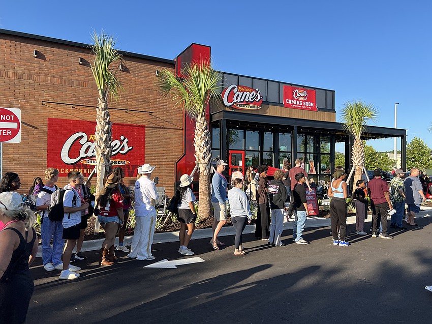 Customers line up July 15 for the opening of the Raising Cane’s Chicken Fingers restaurant in the Oakleaf Station shopping center