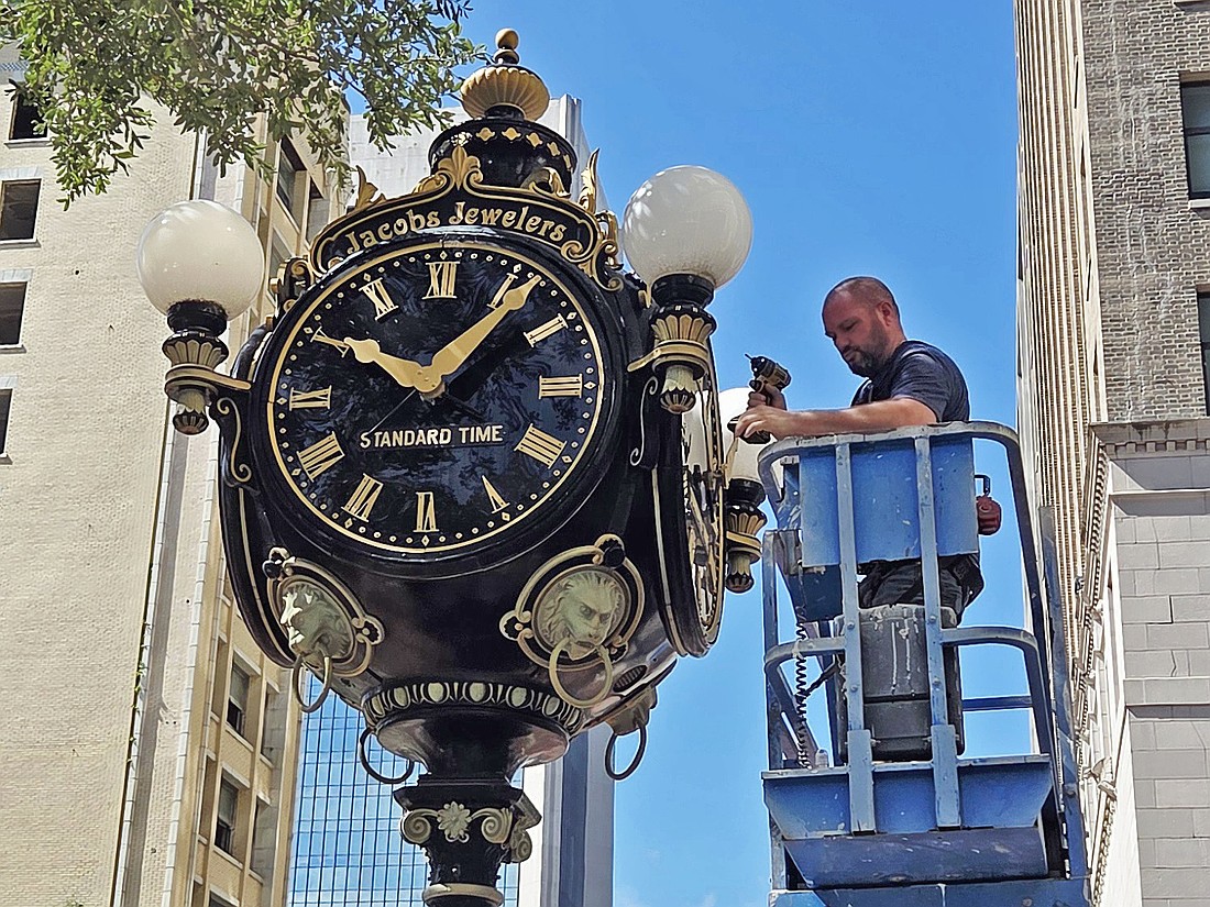 The I.T. Verdin Co. of Cincinnati repairs the historic clock on the corner of Adams and Laura streets July 11.