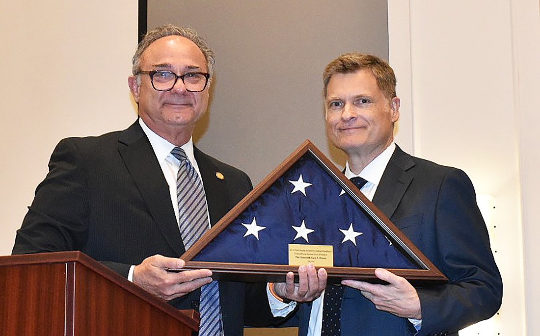 Duval County Judge Gary Flower, left, accepted the Chief Justice Award for Judicial Excellence from state Supreme Court Chief Justice Carlos Muñiz.