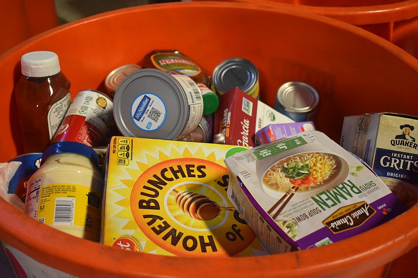 The group of volunteers sorted through bins of food that was donated and determined which food was sealed and still healthy to eat. If it was expired, opened or used it was thrown away.