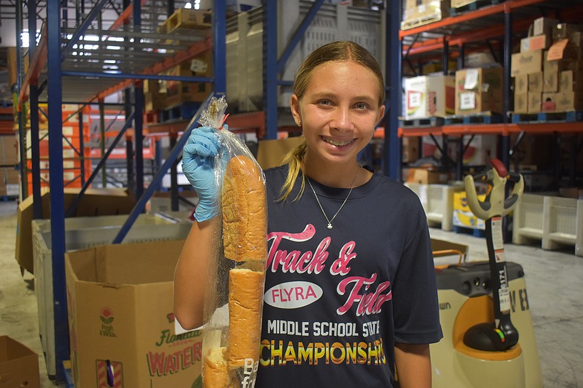 Bradenton resident Sophia Antipov, 12, throws away bread she found that is 