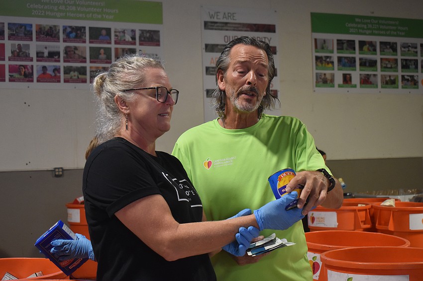 Camela Giraud is the director of collaborative learning and educational outreach at ODA. Bo Bickley is the volunteer associate at All Faiths Food Bank. They work together to determine the expiration date. Depending on how old the food is, the print may not be easily legible.