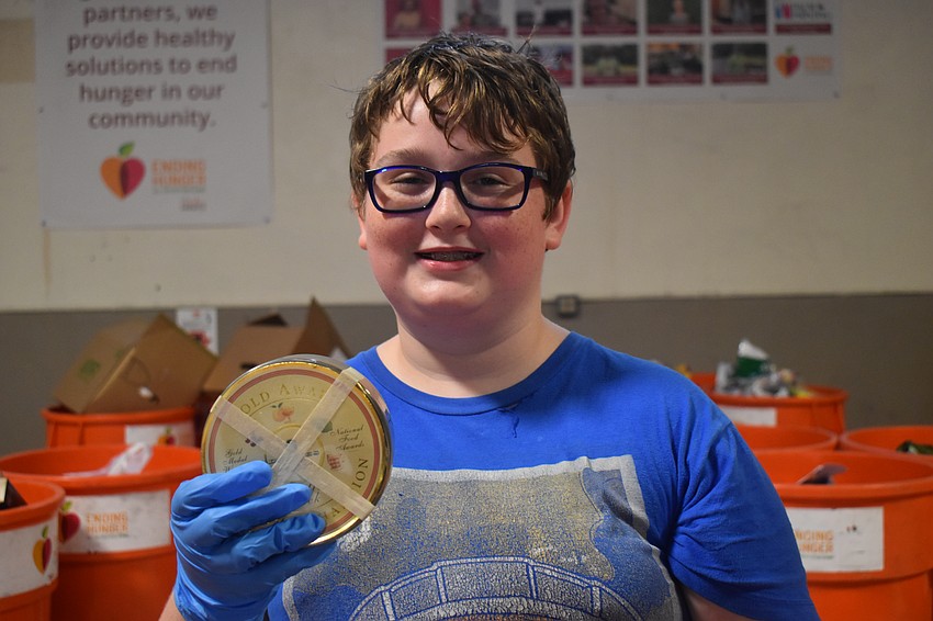 Sarasota resident Owen Tyler, 13, enjoys the challenge of finding and sorting the items. He wants to put more food on the table for people in need.