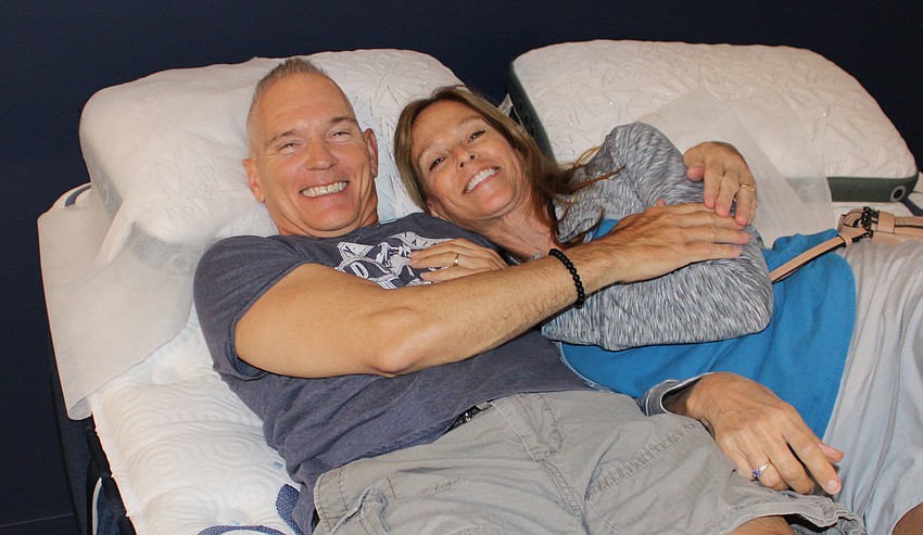Lakewood Ranch's Michael and Gina Bohn try out a mattress at City Furniture's grand opening July 17 at the new UTC east district store.