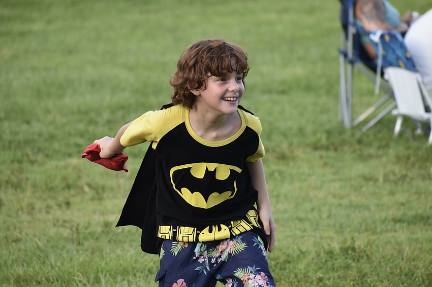 Jonathan Axelrod, 9, throws a beanbag in a game of cornhole.