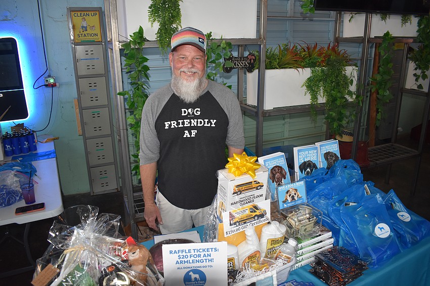Hans Wohlgefahrt stands at the table for Donte’s Den Animal Sanctuary in Myakka City, for which the event featured fundraising.