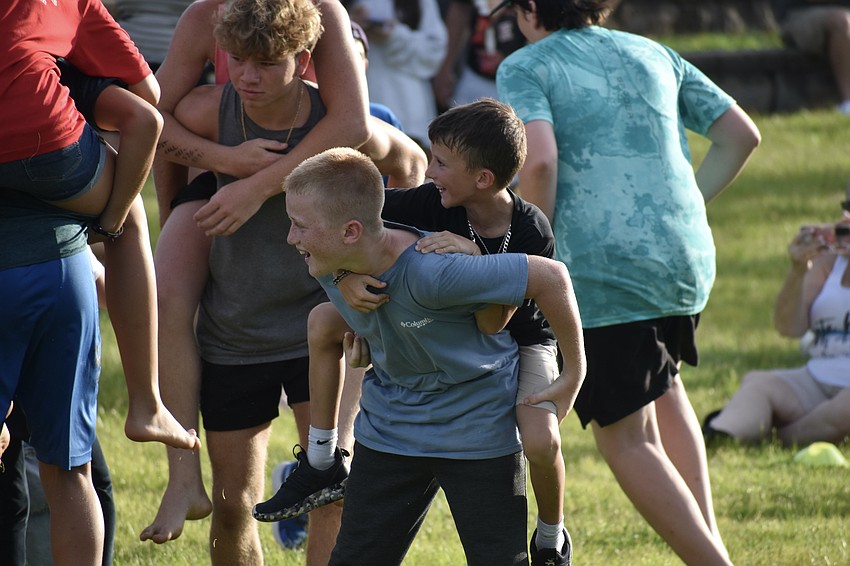 Brayton Dietz, 12, carries his brother Jacob Dietz, 8, during a game that involves siblings picking one another up on command.