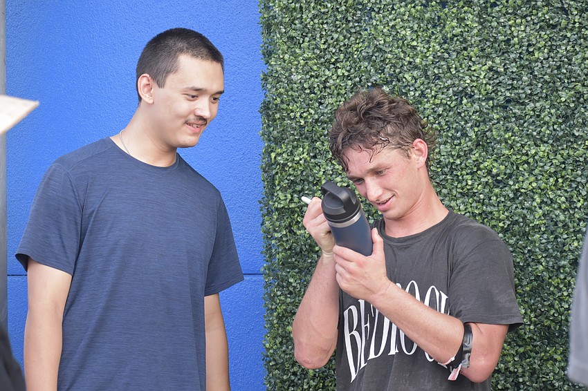 Ryan An gets his bottle signed by Shayne Boyle.