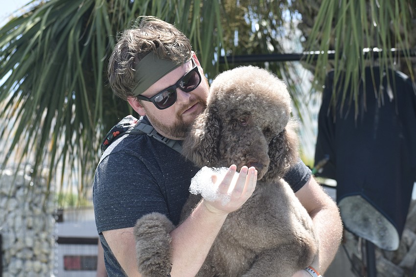 Kevin Quick encourages his dog Lando to enter the foam.