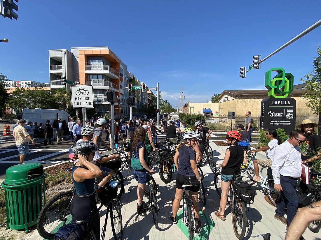 A group of about 30 cyclists attended the ribbon cutting July 21 for the redesigned Park Street in Downtown Jacksonville.
