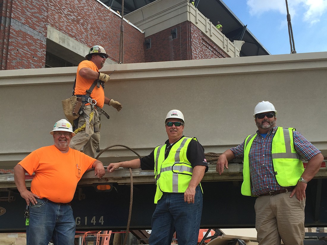 Workers from Gate Precast and Precision Stone work on Truist Park, the home of the Atlanta Braves baseball team.