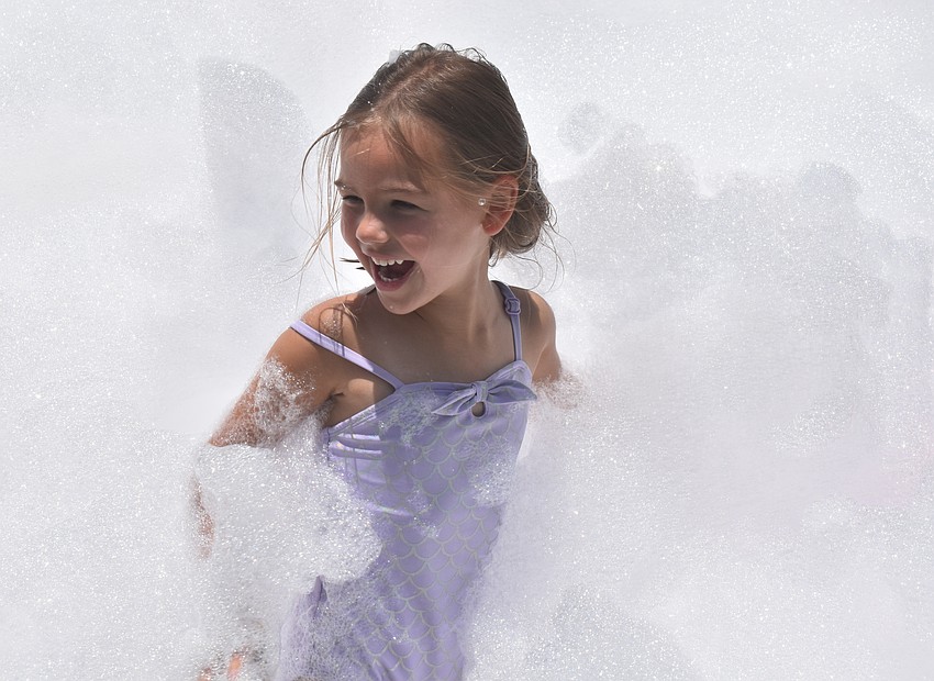 Lakewood Ranch resident Madeline Phillips, 4, felt like a superhero while she was running through the foam during a party at the Creative Child Learning Center in Lakewood Ranch.