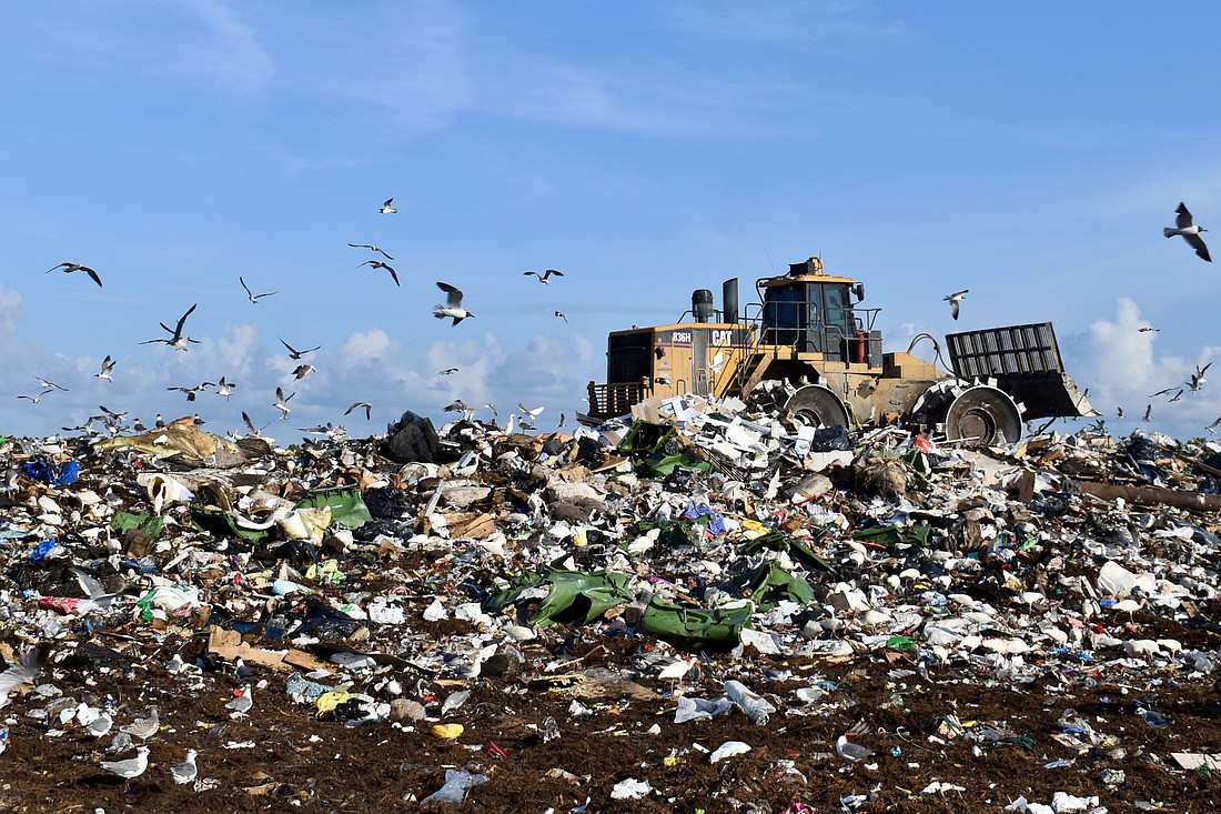 A bulldozer moves trash at the Lena Road Landfill.