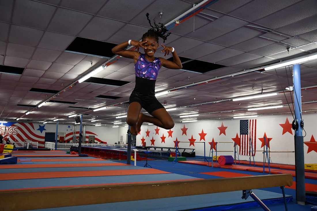Sawyer Roney struck a pose as she jumped off the beam.