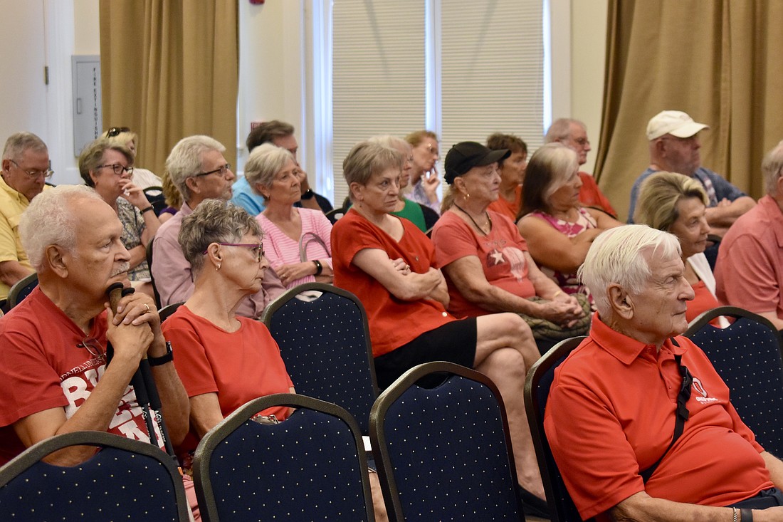 Residents wear red shirts to a Town Hall meeting July 24 to show their opposition to a roundabout on University Parkway at Legacy Boulevard and Deer Drive.