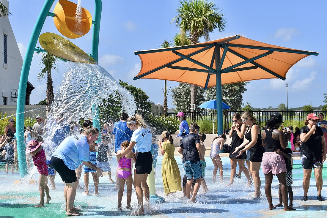 Campers and staff members get soaked by the giant bucket of water.