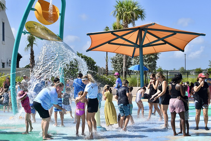 Campers and staff members get soaked by the giant bucket of water.