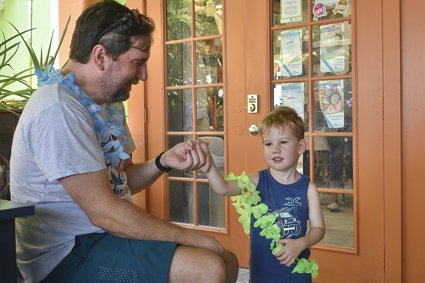 Dan Holmes and his son Parker Holmes, 3, groove to the music.