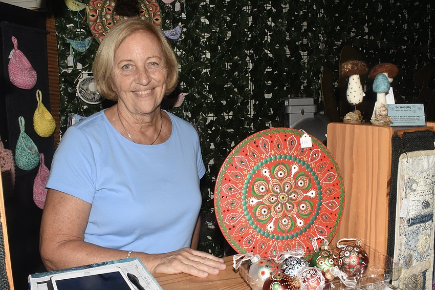 Vendor Gail Saraceno showcases some Christmas ornaments she brought to sell that day.