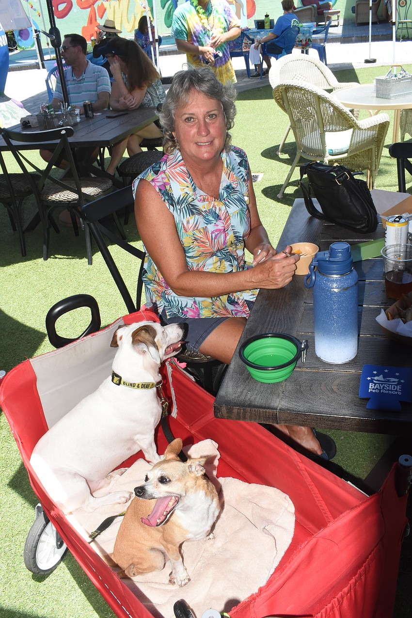 Susie Chinn sits with her two rescue dogs, Keller and Tim, named for Helen Keller and Tiny Tim because of their respective disabilities.