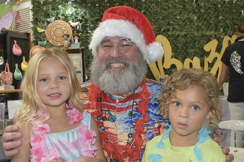 Amelia Adams, 6, Surfer Santa, and Amelia's brother Noah Adams, 4