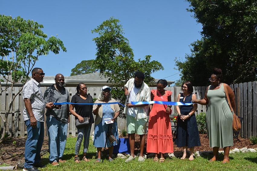 The official ribbon cutting: Victor Jacobs, Jamil Jacobs, Candi Jacobs, Shirley Jacobs, James Jacobs, Addison Jacobs, Colleen Thayer and Shayla Jacobs.