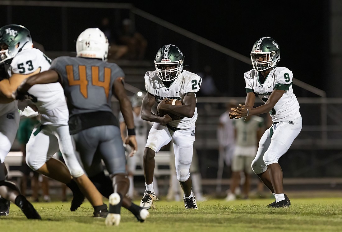 FPC's Ehimen Ajede (24) takes a handoff from LaDarius Simmons (9) during the 2023 Kickoff Classic at Atlantic Coast. Both players are back this year. File photo by Jake Montgomery