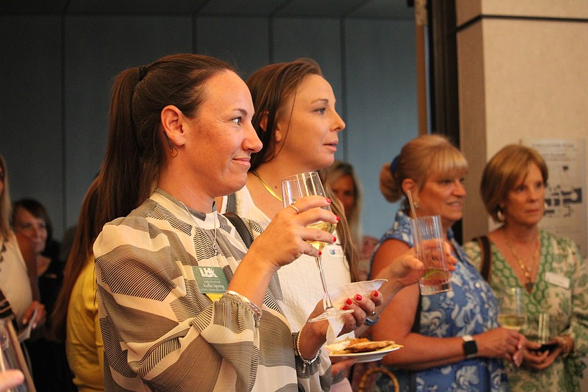 Kellie Spring listens to remarks from Lorna Kirwan, the St. Regis Longboat Key Resort director of sales and marketing.