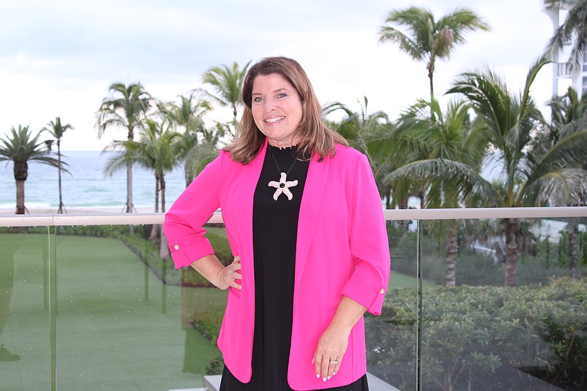 Longboat Key Chamber of Commerce president and CEO Kim Verreault flashes a smile at the July 23 Off the Clock networking event at the St. Regis Longboat Key Resort.