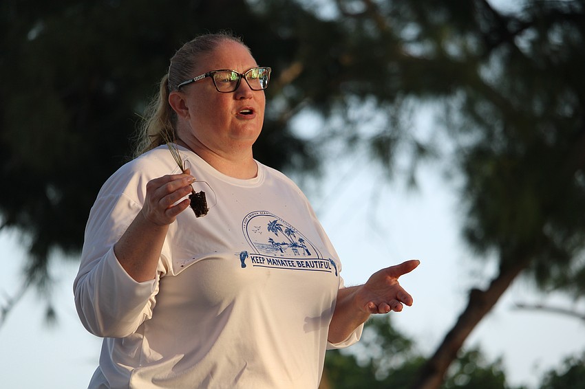 Jennifer Hoffman, executive director of Keep Manatee Beautiful, welcomed volunteers at the Coquina Beach meeting point Saturday morning, explaining how to properly plant a sea oat seedling.