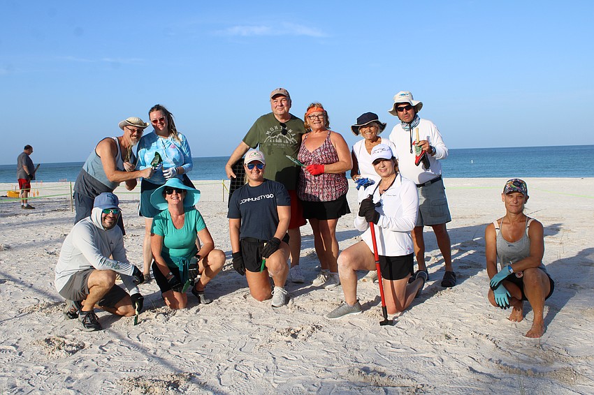 One of the teams at Coquina Beach makes quick work of planting about 70 seedlings in their plot Saturday morning.