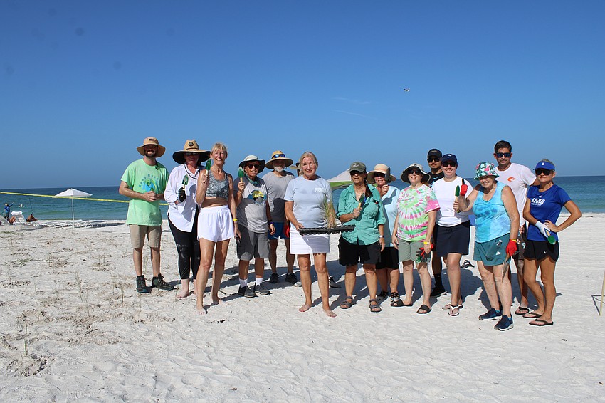 Standing next to their handiwork, the yellow team celebrates planting hundreds of seedlings at Katie Pierola Sunset Park.