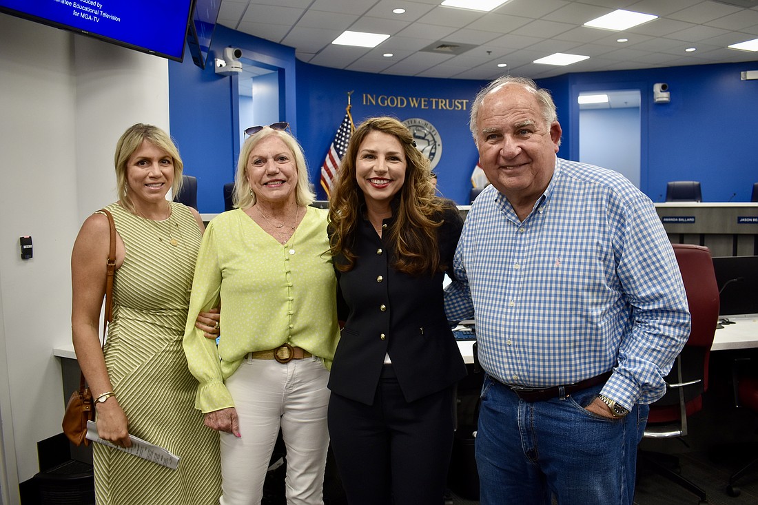 Julie Busa (Janet Mixon's daughter), Janet Mixon, Commissioner Amanda Ballard and Dean Mixon are all smiles on July 29. Manatee County commissioners voted unanimously to purchase Mixon Fruit Farms.