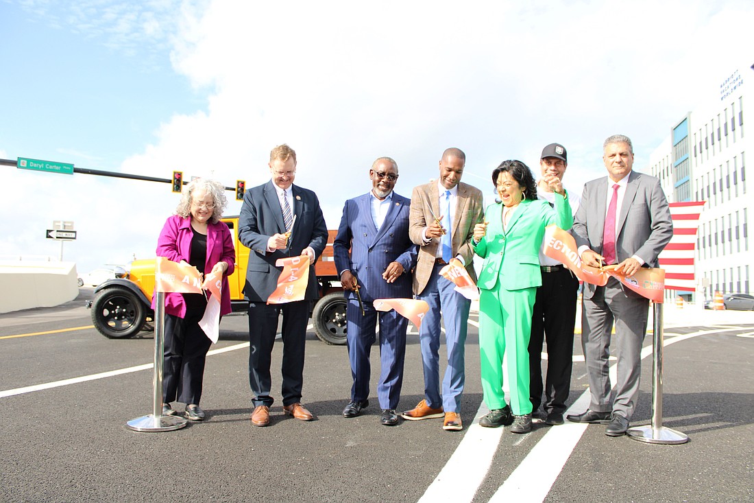 Officials from Orange County, the Florida Department of Transportation, MetroPlan Orlando and other community organizations cut the ribbon to signify the opening of the new Interstate 4 and Daryl Carter Parkway interchange.