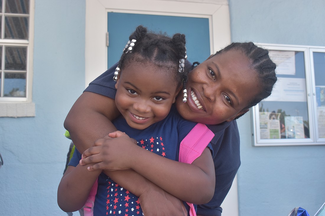 Bradenton residents Sandjina Alexis, 5 and Berline Valcius were thrilled to receive backpacks.