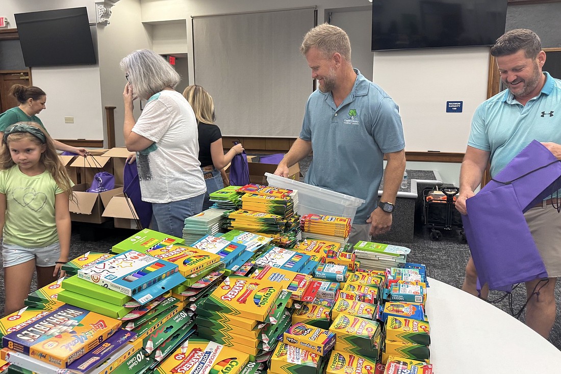 Flagler County Education Foundation volunteers pack supply kits to be handed out at the Back to School Jam. Courtesy photo