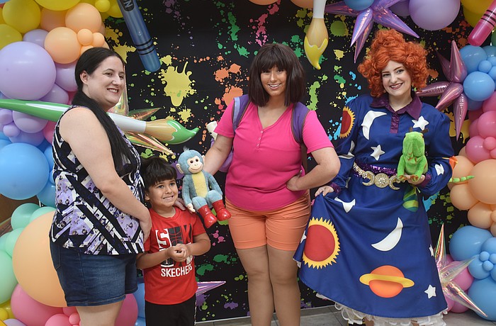 Sarasota resident Dana Crispin and her 4-year-old son Zayden are eager to pose with Dora from "Dora the Explorer" and Valerie Frizzle from "The Magic School Bus."