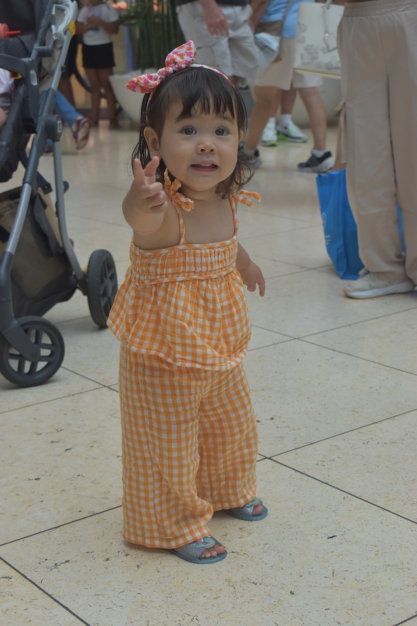 Sarasota resident Cambria Fugleberg, 1, dances along with performers on stage.