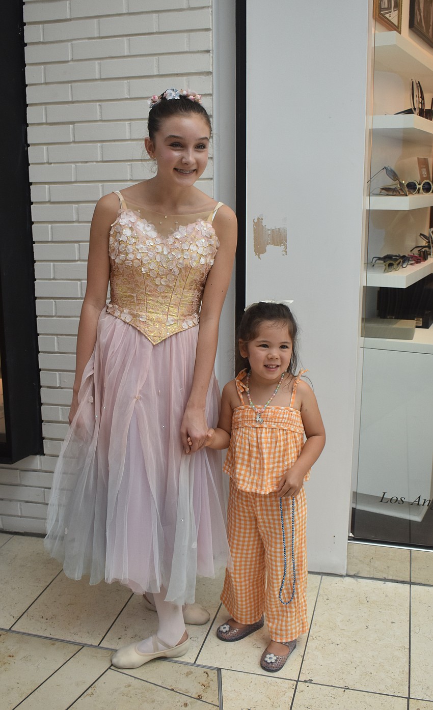 Sarasota resident Elin Mulock, a 13-year-old Sarasota Ballet Dancer, poses with 3-year-old Gloria Fugleberg, who also loves ballet, after the performance.