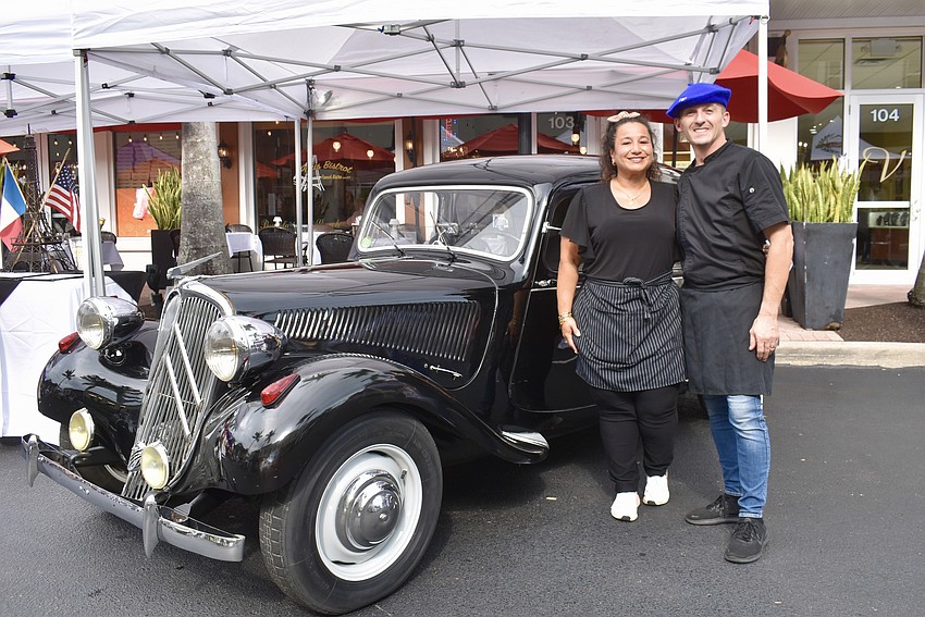 Alexandra and Jean Christophe Nebra, the owners of the Paris Bistrot, park a 1954 Citroen Traction Avant 11BL in front of the restaurant for Music on Main.