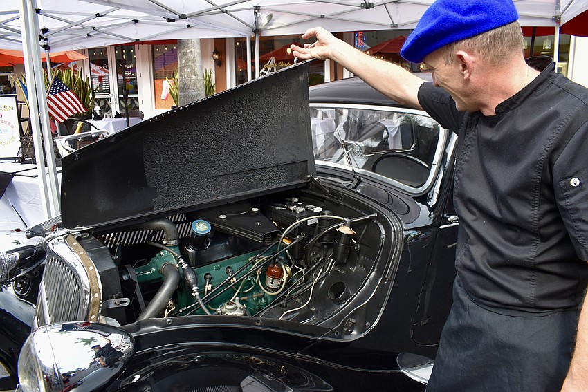 Jean Christophe Nebra opens the hood to show off the engine that was restored last month.