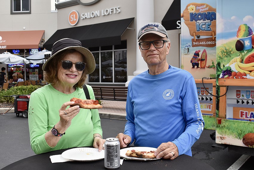 Sarasota's Laurie Foster and Roger Wardwell try the pizza from Percoco's Pizza and Pasta.