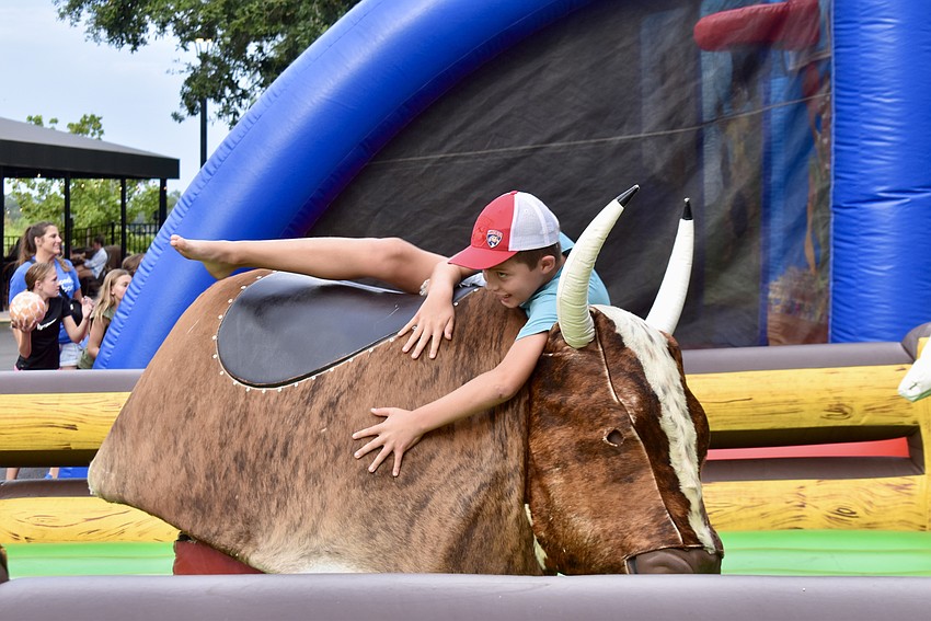 Lakewood Ranch's Bradley Condon, 9, barely hangs on to the mechanical bull.