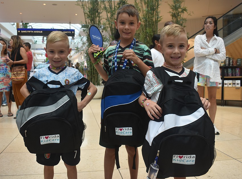 Bradenton residents Clayton, Ashton and Preston Nicholson all get to bring home free backpacks with school supplies. Clayton and Preston are looking forward to art class and Ashton is looking forward to math once school starts.