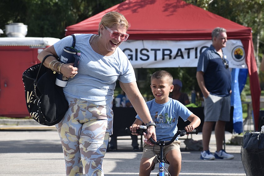 Lisbett Remedios and her son Jeremiah Vidal, 5, head to the helmet station.