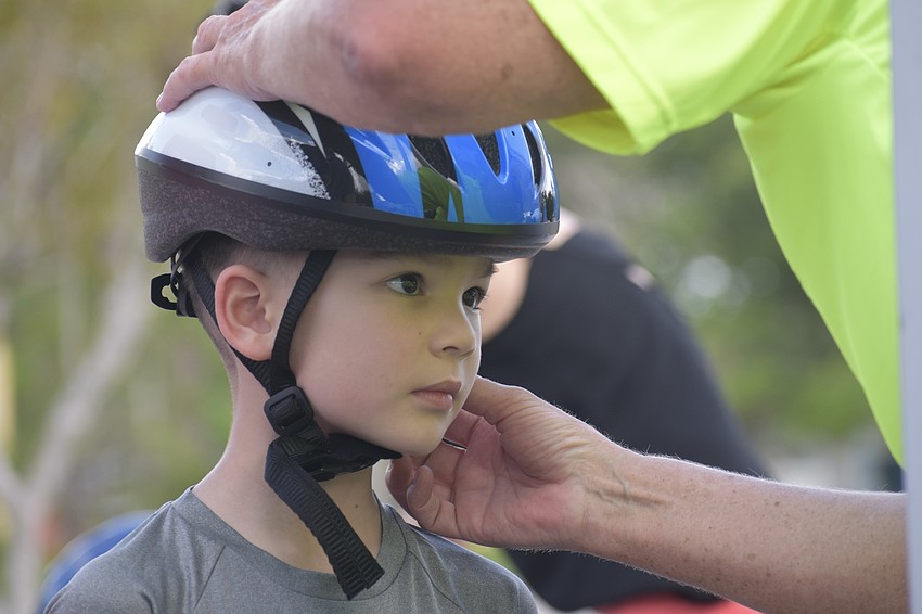 Tristan Prybylski, 5, receives a helmet.