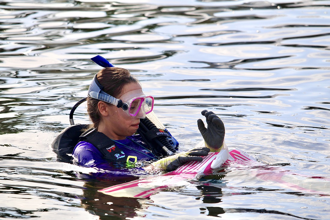 Coco Claypoole, who recently founded the Florida branch of the youth environmental group Bubbles of Hope, prepares for a Sunday morning dive in Venice.