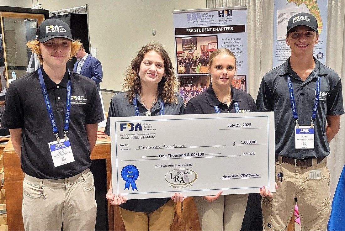 Matanzas High School building construction students Nolan Schmidt, Emma Guldan, Gabi Spence and Blaine Vogel accept the check for $1,000 for their second-place finish at the Future Builders of America Design/Build Competition. Courtesy photo