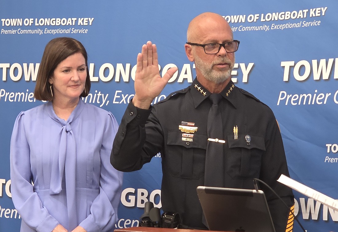 Town of Longboat Key Police Chief Russ Mager is sworn in on his first day Aug. 4 as his wife, Beth, looks on.